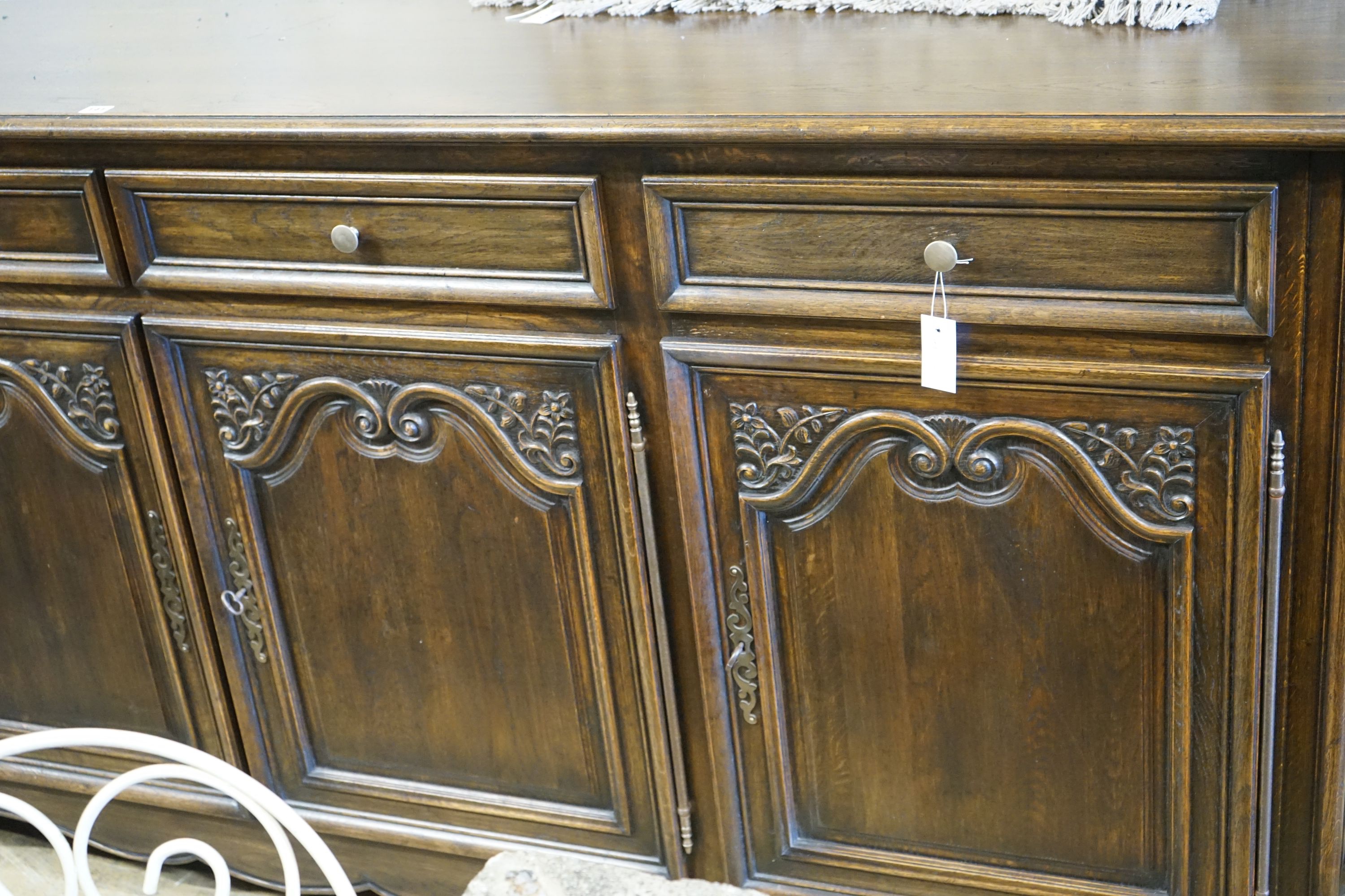 An 18th century style French oak four door buffet, length 260cm, depth 52cm, height 110cm